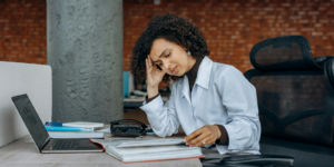 woman with her head on her hand looking at a book. DIY personal injury claims