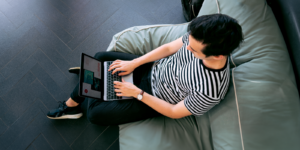 Man sitting on a chair with laptop. Online legal advice limitations