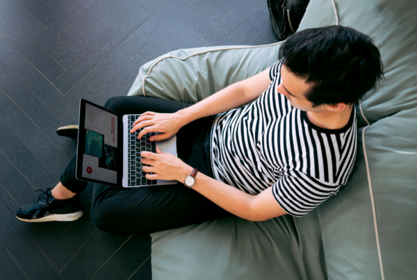 Man sitting on a chair with laptop. Online legal advice limitations