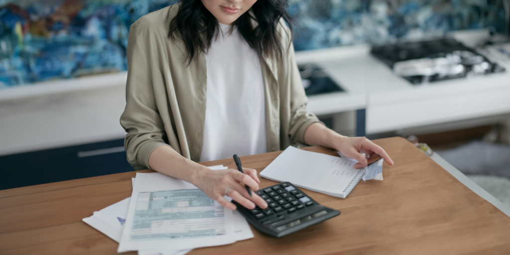 Woman at desk with calculator