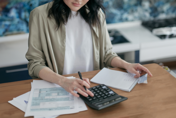 Woman at desk with calculator