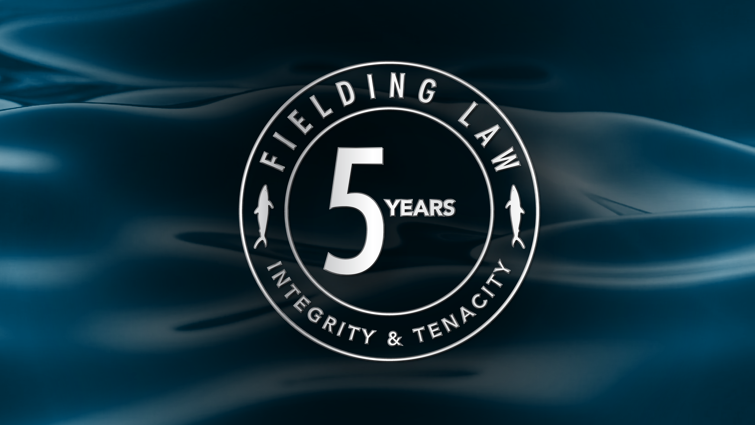 Fielding Law 5 Year Anniversary logo on dark water background