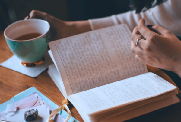 Person reading and writing in a journal