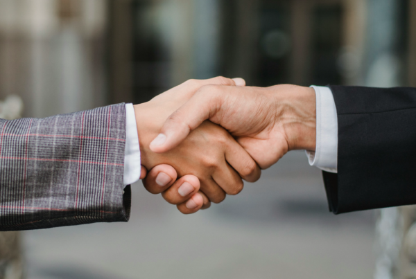 Two people shaking hands. Certificate of Merit