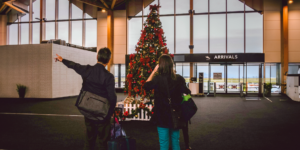 Couple at an airport to travel for the Christmas Holiday.