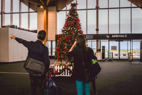 Couple at an airport to travel for the Christmas Holiday.