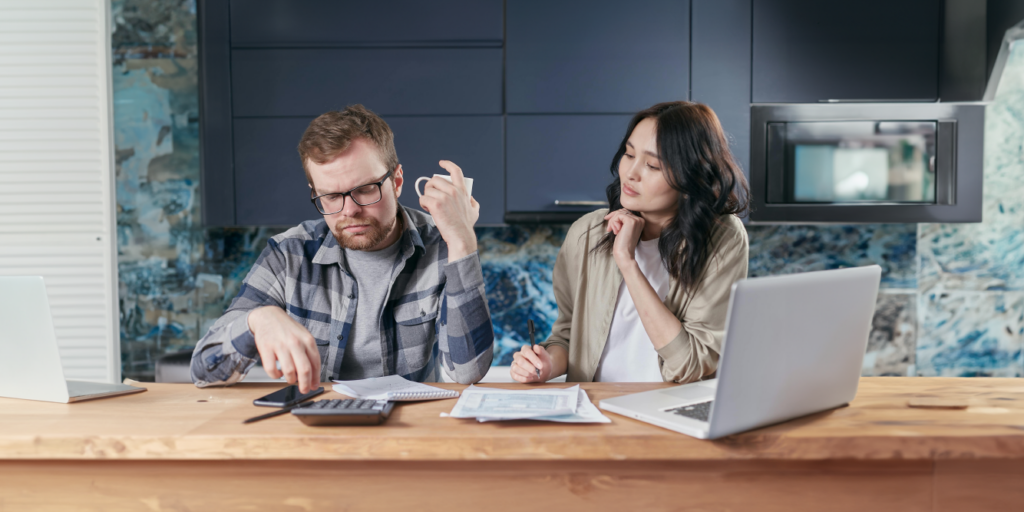 Couple sitting at a table looking over their liens