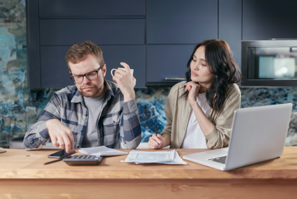 Couple sitting at a table looking over their liens