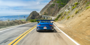 Blue sports car on a california highway