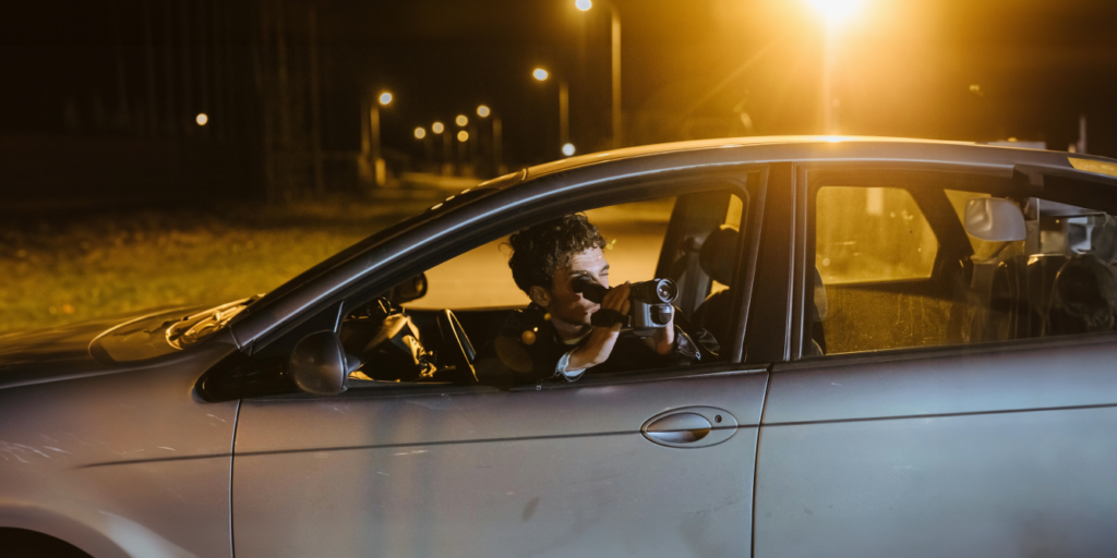 Man conducting surveillance from car.