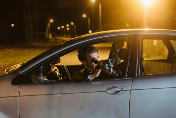 Man conducting surveillance from car.