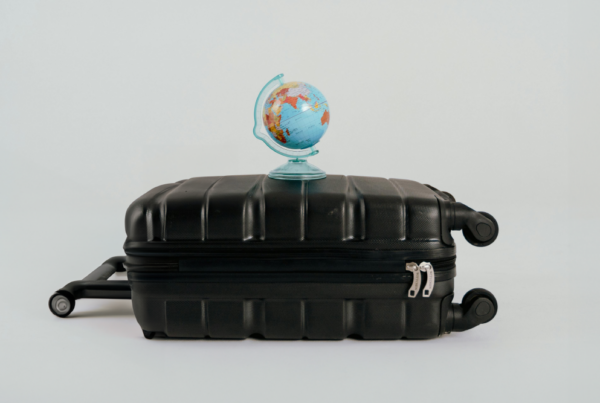 Wheeled suitcase for travel and a globe