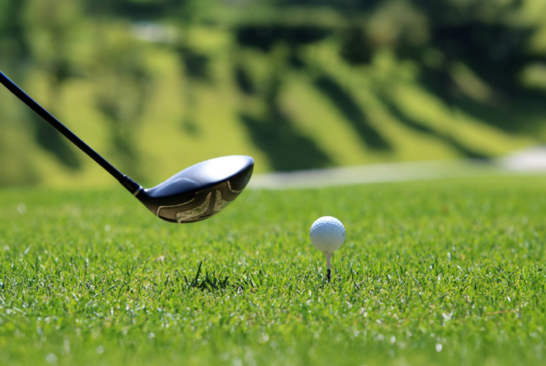 Golf club and golf ball on a tee.