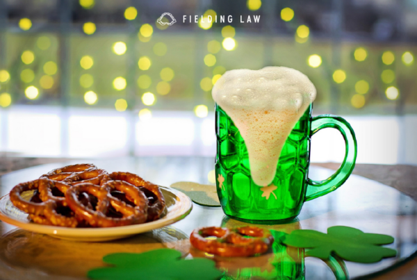 St. Patrick's Day decor with a green glass of beer and a plate of pretzels