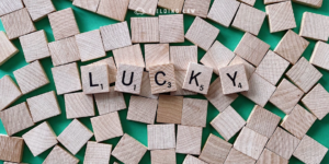 Wood tiles with letters that spell our lucky for St. Patrick's day with a green background