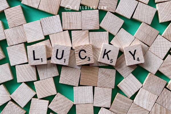 Wood tiles with letters that spell our lucky for St. Patrick's day with a green background