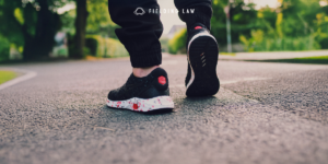 Person walking on pavement. Close up on the shoes