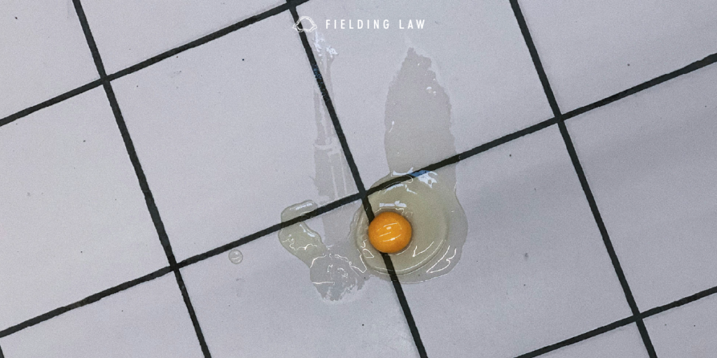 a broken egg on the tile of a store