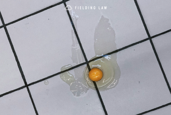 a broken egg on the tile of a store