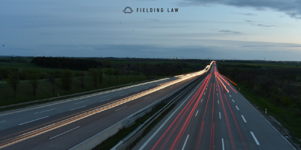 freeway at dusk with headlight and tail light streaks