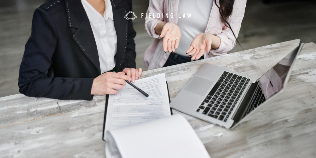 an insurance adjuster sitting with a client and chatting about an accident