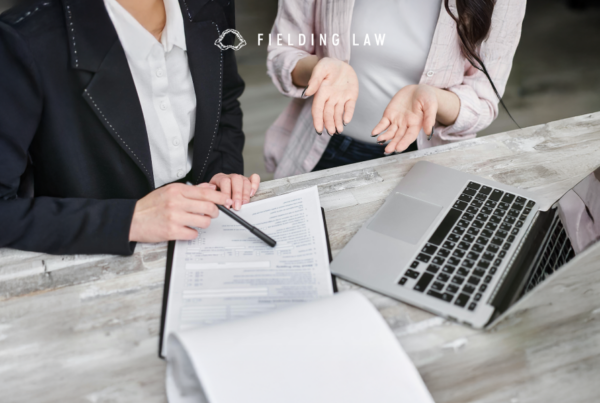 an insurance adjuster sitting with a client and chatting about an accident