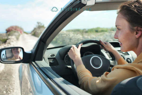 woman driving car down a gravel road