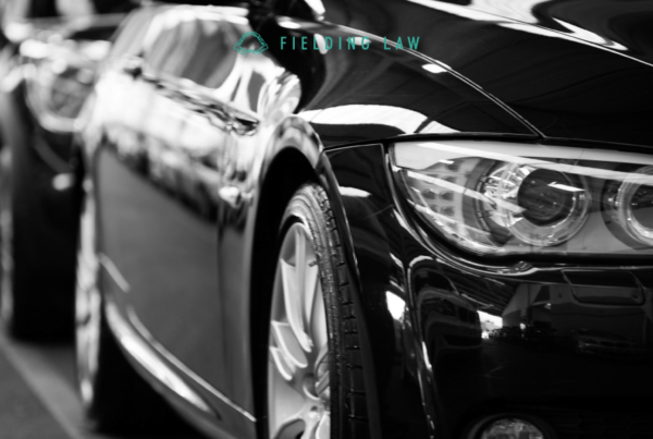 black and white photo of cars lined up on a street