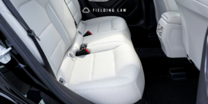 Seatbelt in the back of a car with white seats