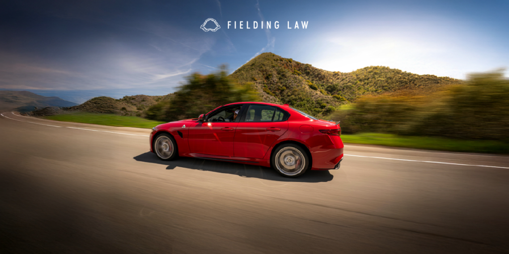 Red car on freeway near Camp Pendleton