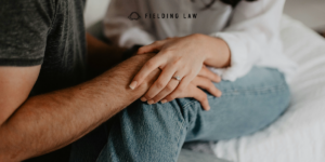 two people holding hands consoling each other after a catastrophic injury