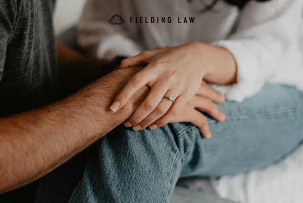 two people holding hands consoling each other after a catastrophic injury