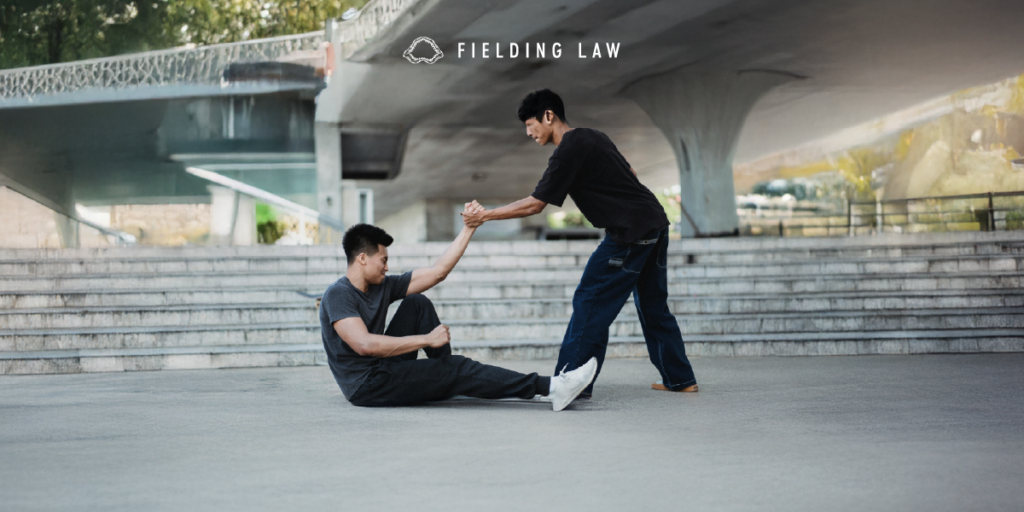 A good samaritan lending a helping hand to help a person up off the ground