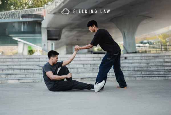 A good samaritan lending a helping hand to help a person up off the ground