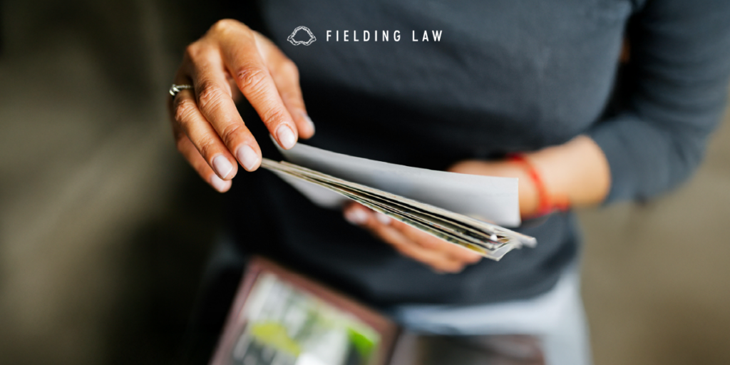 Person holding photo evidence in their hands