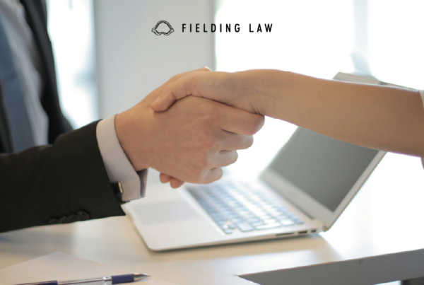 two people shaking hands after a close of an injury case