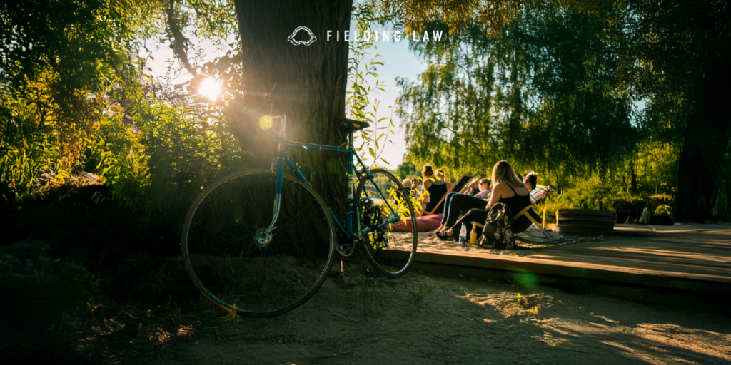 People gathered on a trail with bikes in the woods