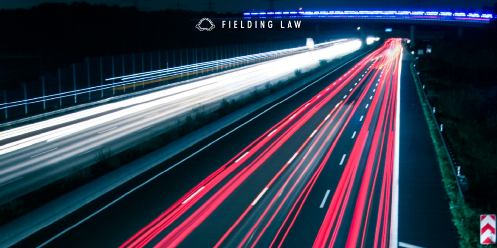 Busy road at night with streaks of tail lights and headlights