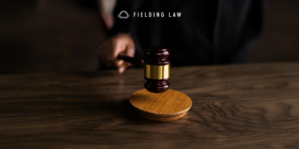 court room gavel with a handle holding it