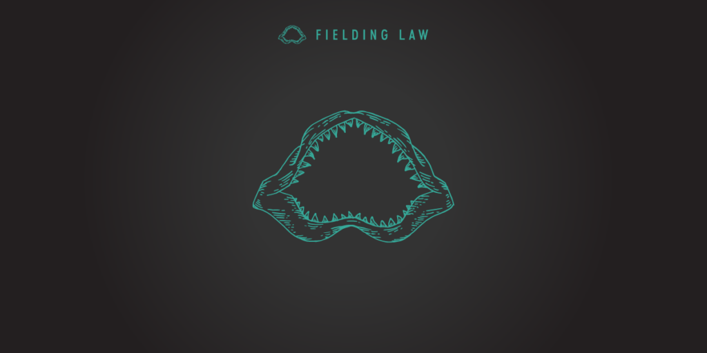 Fielding Law jaw logo on black background