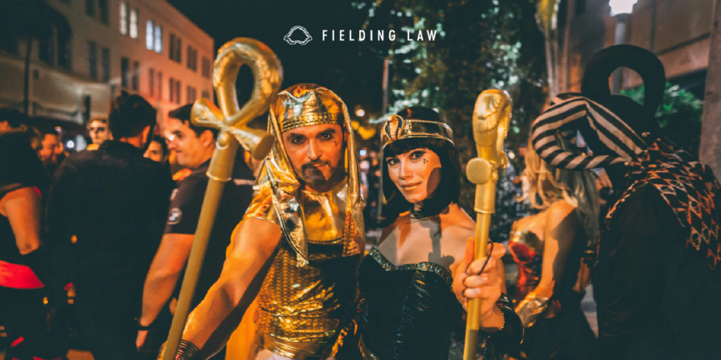 People at a Halloween event outside with costumes on