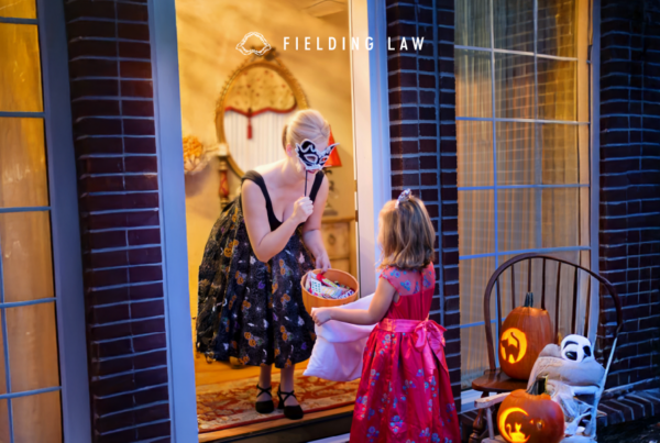 Front Door with a lady giving halloween candy to a child