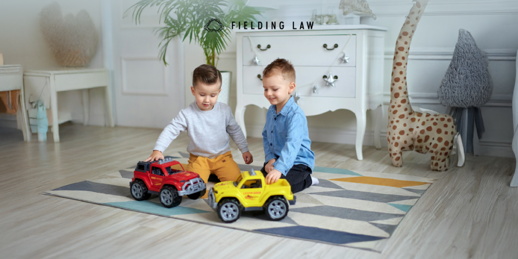 Two minors playing with toys