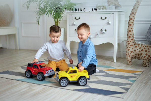 Two minors playing with toys