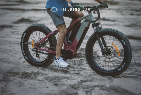 Person riding an e-bike on sand