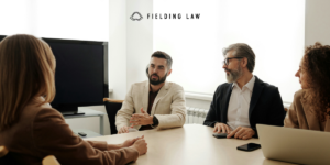 4 people in a conference room for a deposition