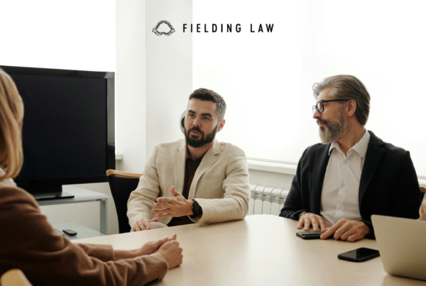 4 people in a conference room for a deposition