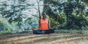 Woman sitting in the woods meditating