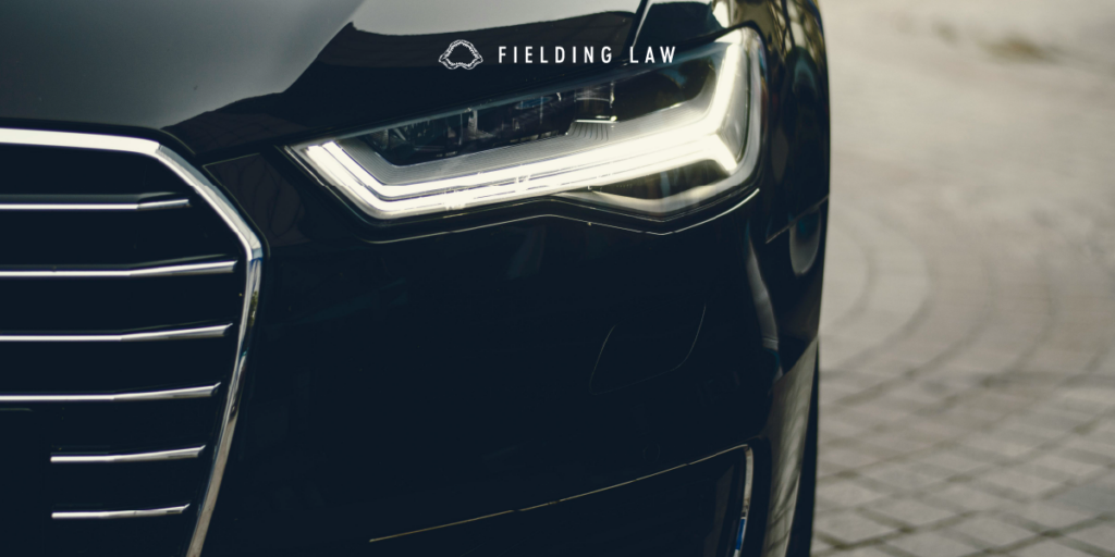 Front of a car showing mostly the headlight