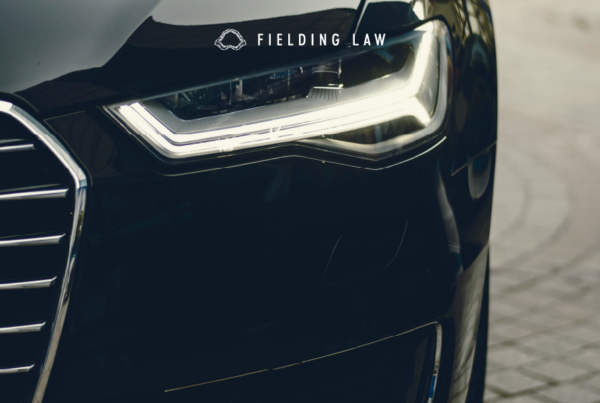 Front of a car showing mostly the headlight